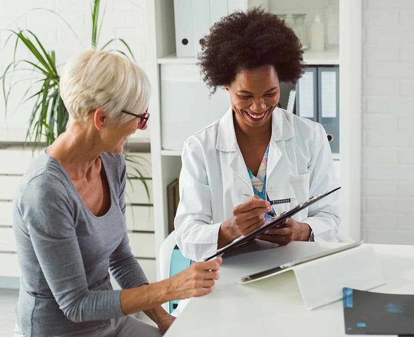 A doctor helping an old woman