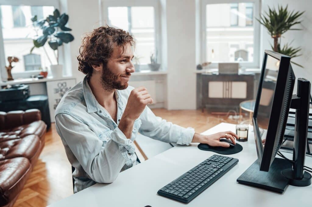 cheerful-guy-works-from-home-with-computer-security