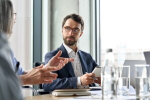 business leader attentively listening to a colleague during a cybersecurity meeting