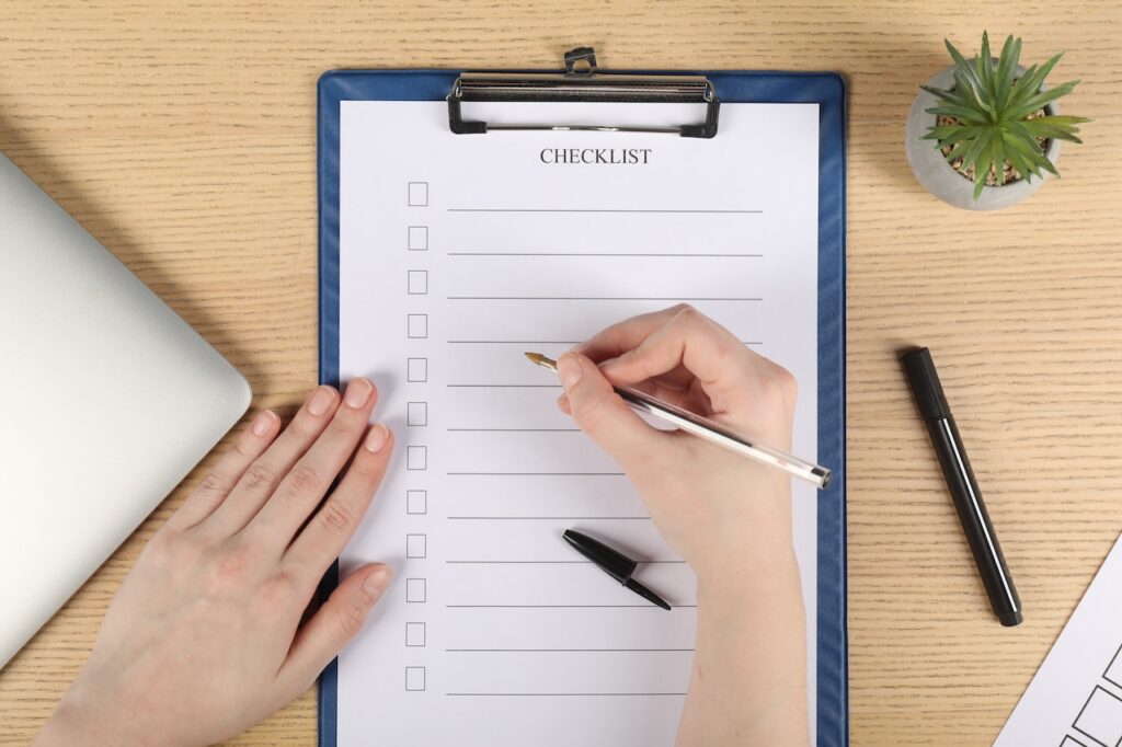 woman filling out employee offboarding checklist